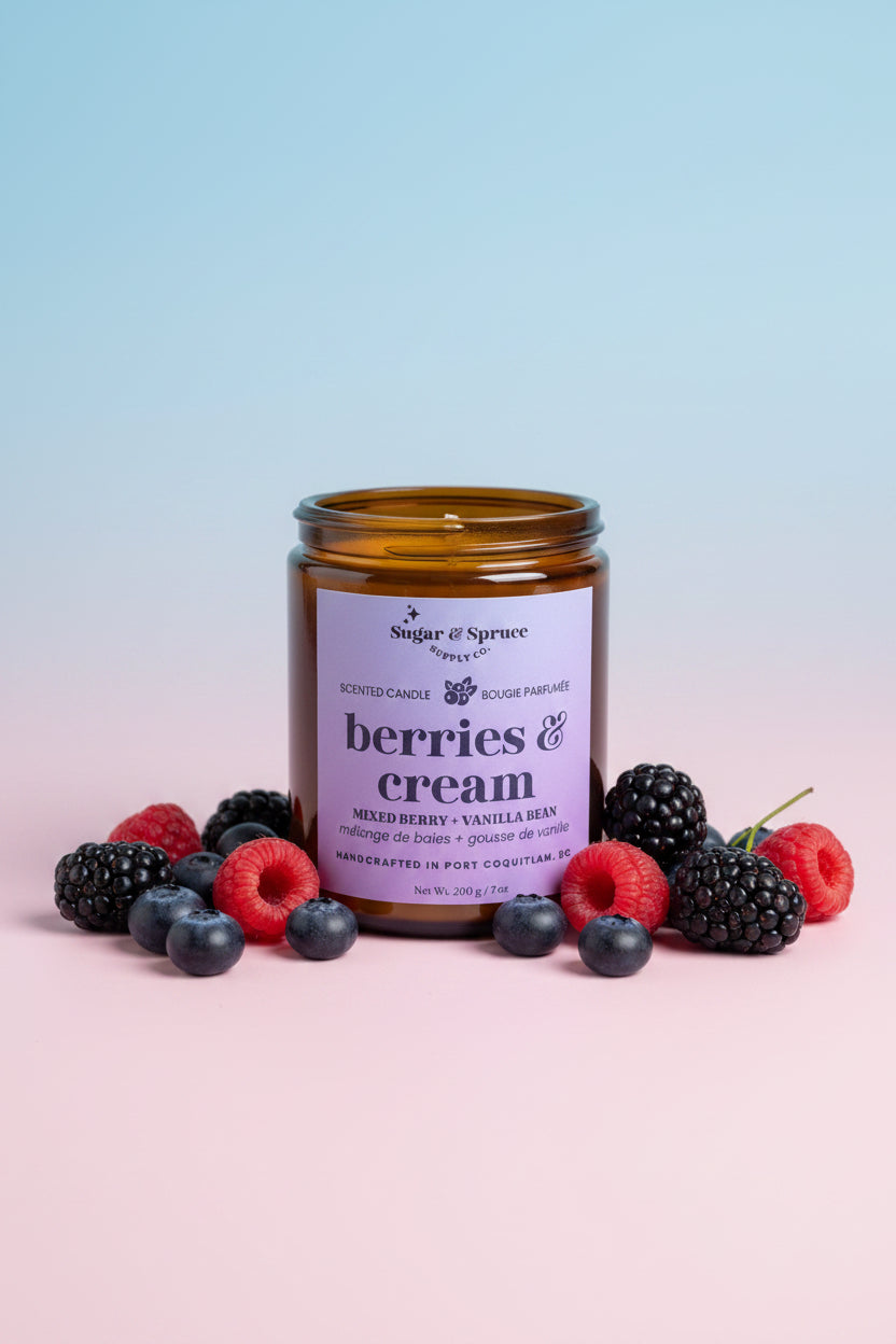 Candle jar labeled 'berries & cream' with berries on a gradient background